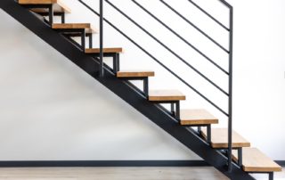 Loft style staircase. Black steel and wood. Geometric architecture.